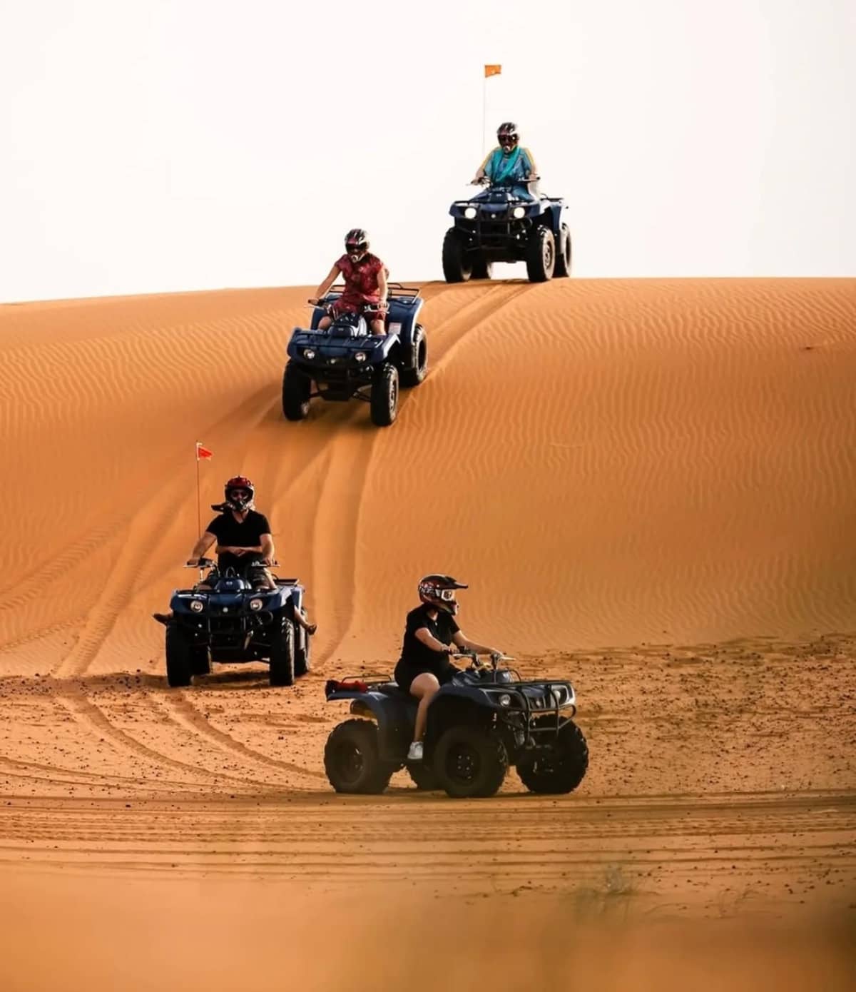 quad biking across erg chebbi dunes on fes to marrakech desert tour 4 days