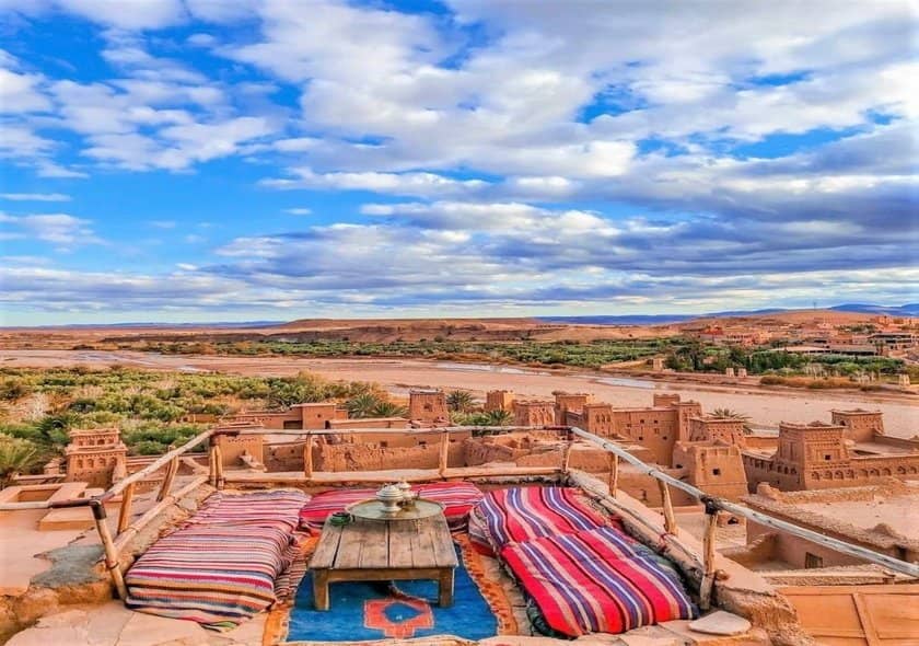 Historic mud-brick ksar of Ait Ben Haddou in Morocco, featuring traditional earthen architecture, fortified towers, and a stunning desert landscape backdrop