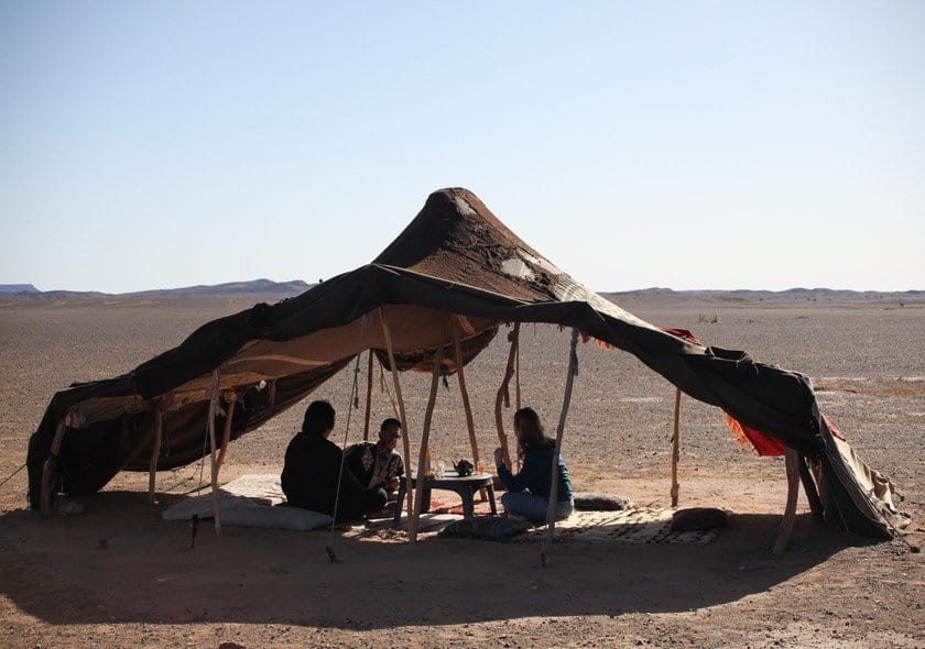 Berber nomad family sharing traditional Moroccan culture during a Fes to Marrakech Desert Tour